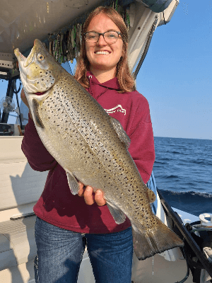 Young lady holding Lake Ontario Brown Trout during the 2024 season.